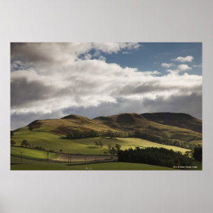A Landscape With Rolling Hills And Clouds Overhead Poster
