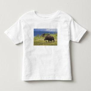 A large bull moose stands among willows toddler T-Shirt
