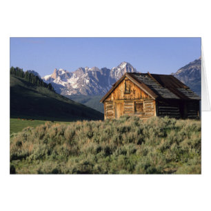 A log cabin and the Sawtooth Mountains in