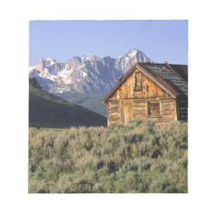 A log cabin and the Sawtooth Mountains in Notepad