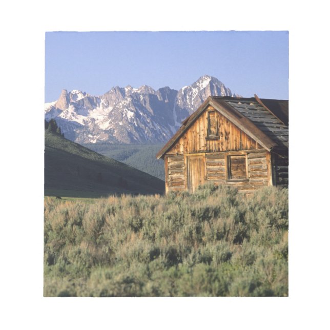 A log cabin and the Sawtooth Mountains in Notepad (Front)