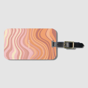 A luggage tag with sunset colours in waves.