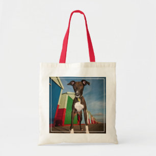 A Lurcher Standing In Front Of Some Beach Huts Tote Bag