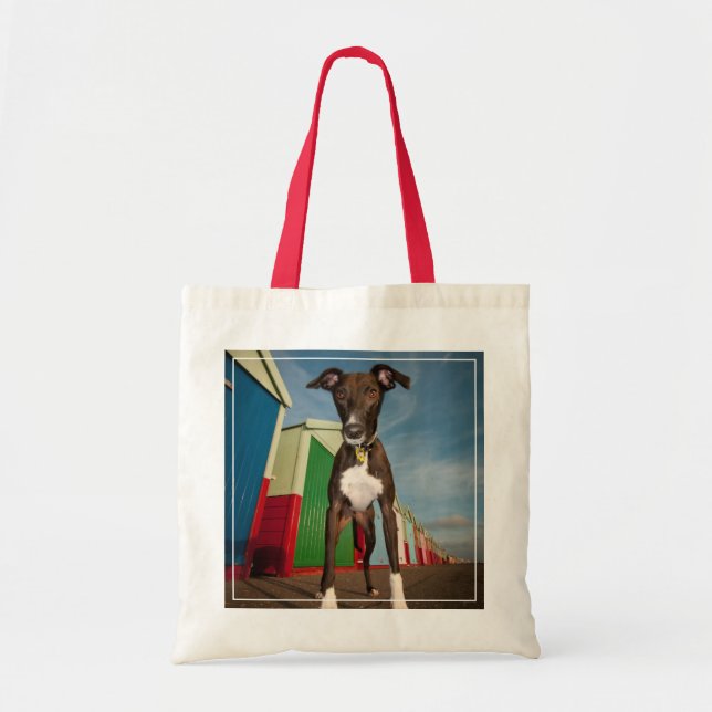 A Lurcher Standing In Front Of Some Beach Huts Tote Bag (Front)