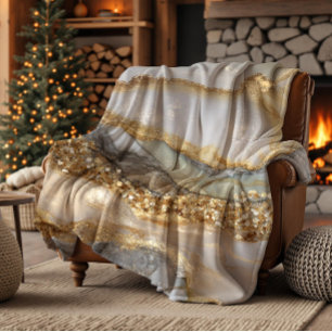 A luxurious gold and white marble background fleece blanket