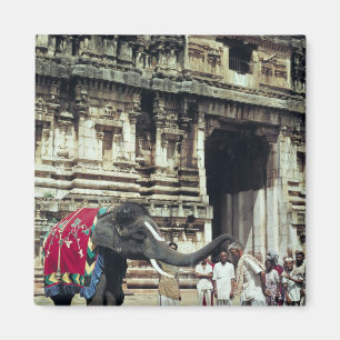 A man being blessed by an elephant magnet