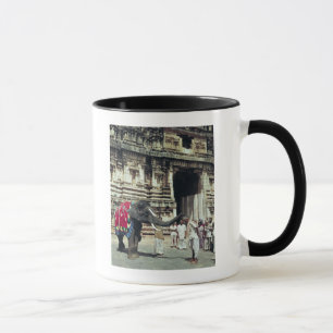 A man being blessed by an elephant mug