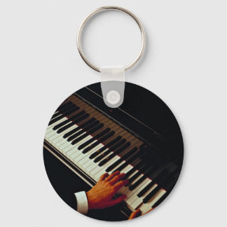 A man playing piano key ring