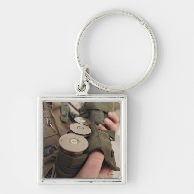 A Marine cradles handfuls of 40 mm grenades Key Ring (Front)