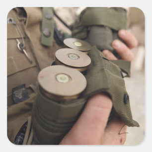 A Marine cradles handfuls of 40 mm grenades Square Sticker
