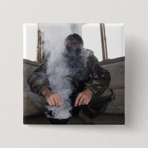 A marine fills the gas chamber with more CS gas 15 Cm Square Badge