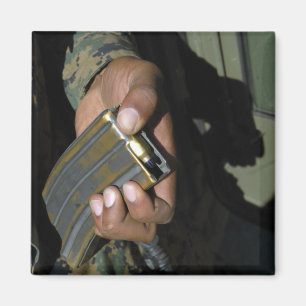 A Marine loads blank ammunition rounds Magnet