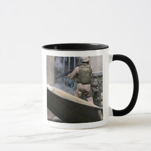 A military policeman uses a breaching round mug