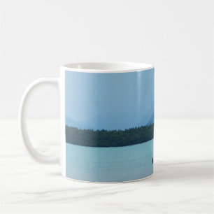 A MOTHER BEAR TEACHES HER CUBS TO SWIM ON THE EDGE COFFEE MUG
