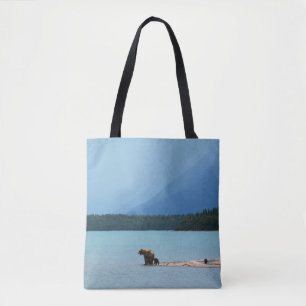 A MOTHER BEAR TEACHES HER CUBS TO SWIM ON THE EDGE TOTE BAG