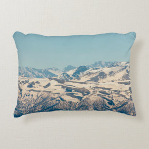 A mountain range with thawing snow and ice in the decorative cushion