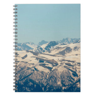A mountain range with thawing snow and ice in the  notebook