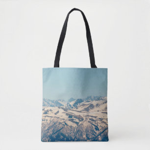 A mountain range with thawing snow and ice in the tote bag