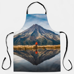 A mountaineer with an orange dress in a symmetric apron