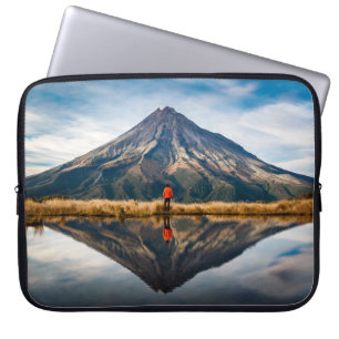 A mountaineer with an orange dress in a symmetric laptop sleeve