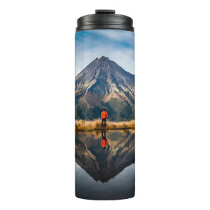 A mountaineer with an orange dress in a symmetric thermal tumbler