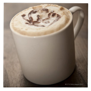 A mug of Cappuccino coffee topped with melted Ceramic Tile