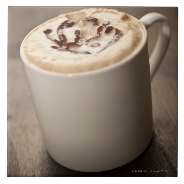 A mug of Cappuccino coffee topped with melted Ceramic Tile (Front)