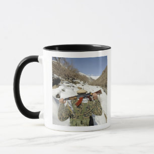 A Mujahadeen Guard walks with US Military membe Mug