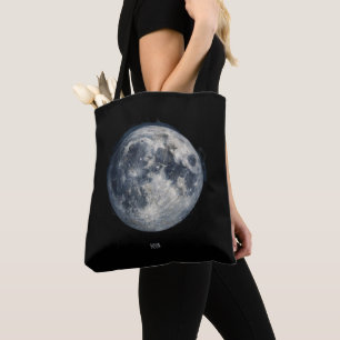 A painting of the moon in a space tote bag