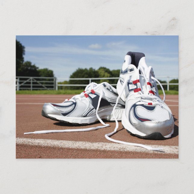 A pair of new white running trainers are placed postcard (Front)