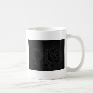 A pair of roses in black coffee mug