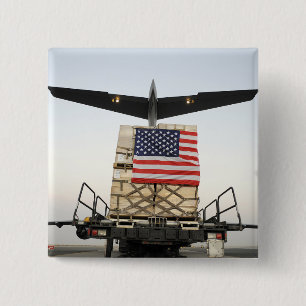 A pallet containing humanitarian relief supplie 15 cm square badge