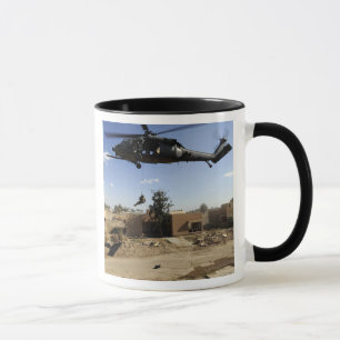 A pararescueman rappels from an HH-60 2 Mug