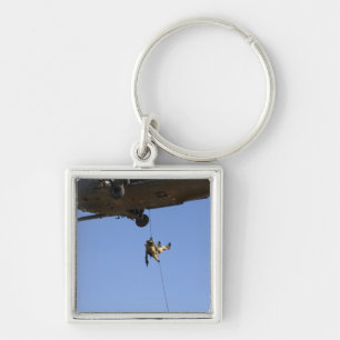 A pararescueman rappels from an HH-60 Key Ring