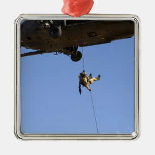 A pararescueman rappels from an HH-60 Metal Ornament