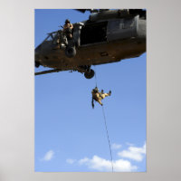 A pararescueman rappels from an HH-60