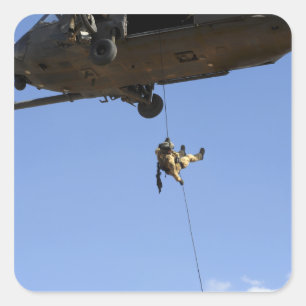 A pararescueman rappels from an HH-60 Square Sticker