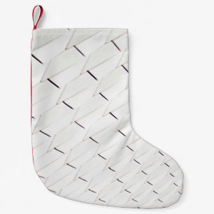 A pattern of white geometric shapes in a facade small christmas stocking