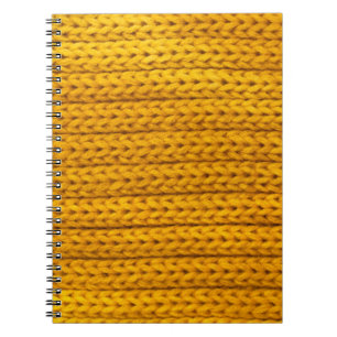 A pattern of yellow knitted fabric of yarn. notebook