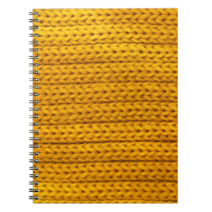 A pattern of yellow knitted fabric of yarn. notebook
