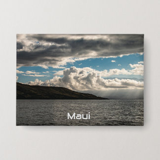 A pin featuring clouds over Maui 