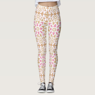 a pink and white flower pattern on a brown backgro leggings