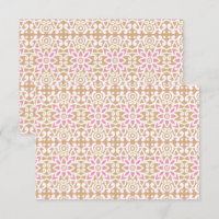 a pink and white flower pattern on a brown backgro