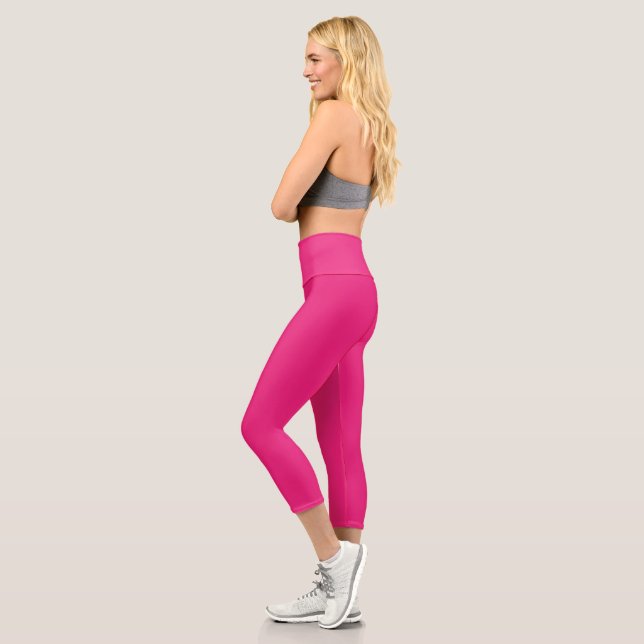 a pink background with a black border capri leggings (Left)