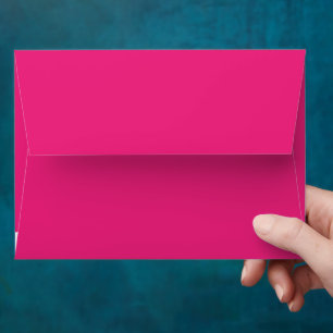 a pink background with a black border envelope