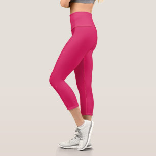 a pink background with a white border capri leggings