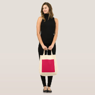 a pink background with a white border tote bag