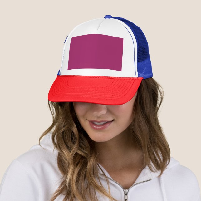 a pink background with a white border trucker hat (In Situ)