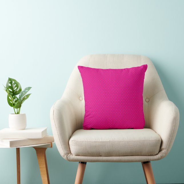 a pink background with white polka dots cushion (Chair)