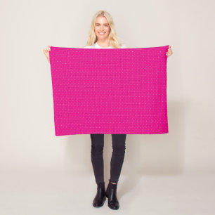 a pink background with white polka dots fleece blanket